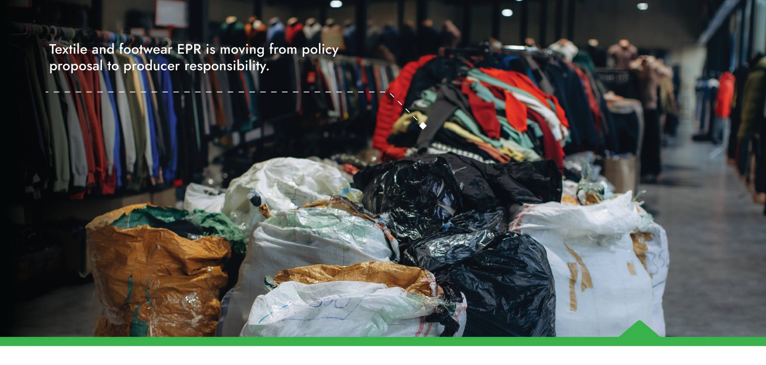 Retail clothing racks above textile waste collection bags illustrating textile and footwear EPR moving from policy proposal to producer responsibility